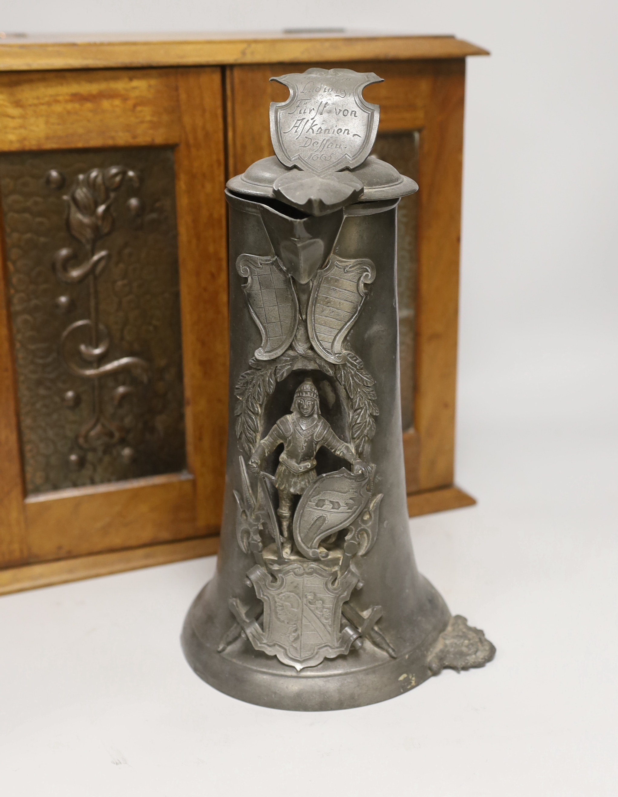 A German pewter commemorative flagon and an Art Nouveau smoker's cabinet
